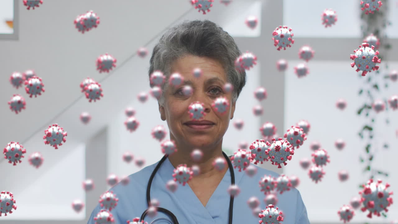 Animation of covid 19 cells over smiling female doctor with stethoscope