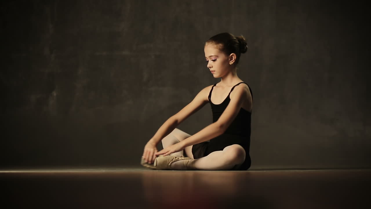 Beautiful little girl ballerina dancing in ballet studio