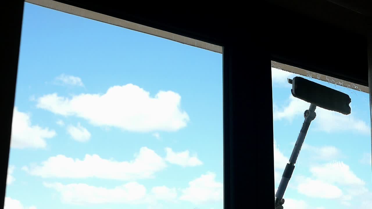 Blue Sky with White Clouds Seen Through a Window