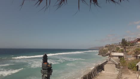 rural bali indonesia village with hidden sandy beach and ocean in background. sunny and windy day in nusa penida