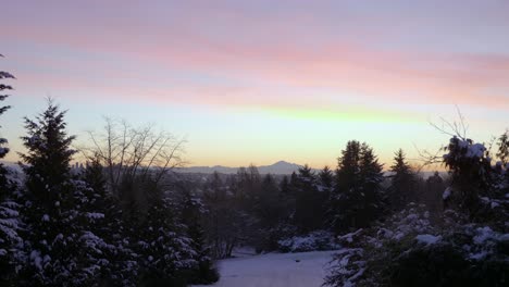 unrecognizable person sliding on snow, mount baker in background