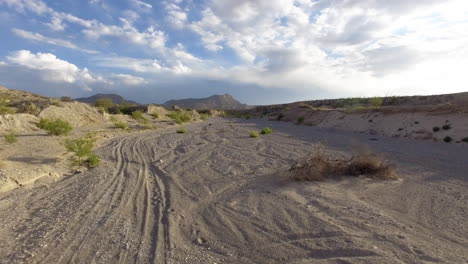 aerial ground level shot of an empty bike trail in the desert