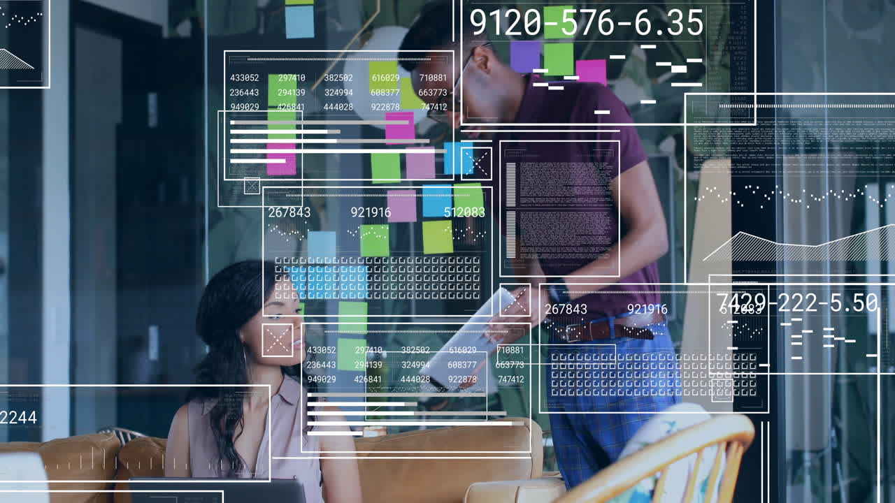Female coworker using laptop and male coworker showing printed data in office with floating charts