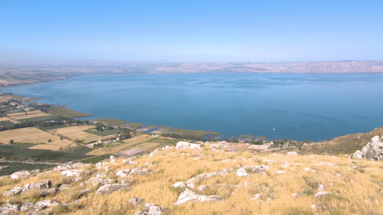 The beautiful blue Sea of Galilee from the rocky Arbel cliff mountain - wide rolling