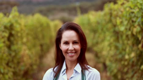 Brunette-winegrower-holding-a-red-grape-basket-