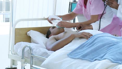 doctor and nurse examining a patient in bed