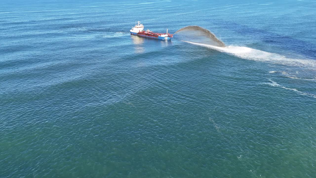 Aerial view of a dredging ship pumping sand into the ocean, addressing beach erosion on the Gold Coast, Australia
