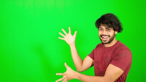 Indian-guy-point-out-with-green-background-indian-guy-standing-on-green-screen---chroma-key