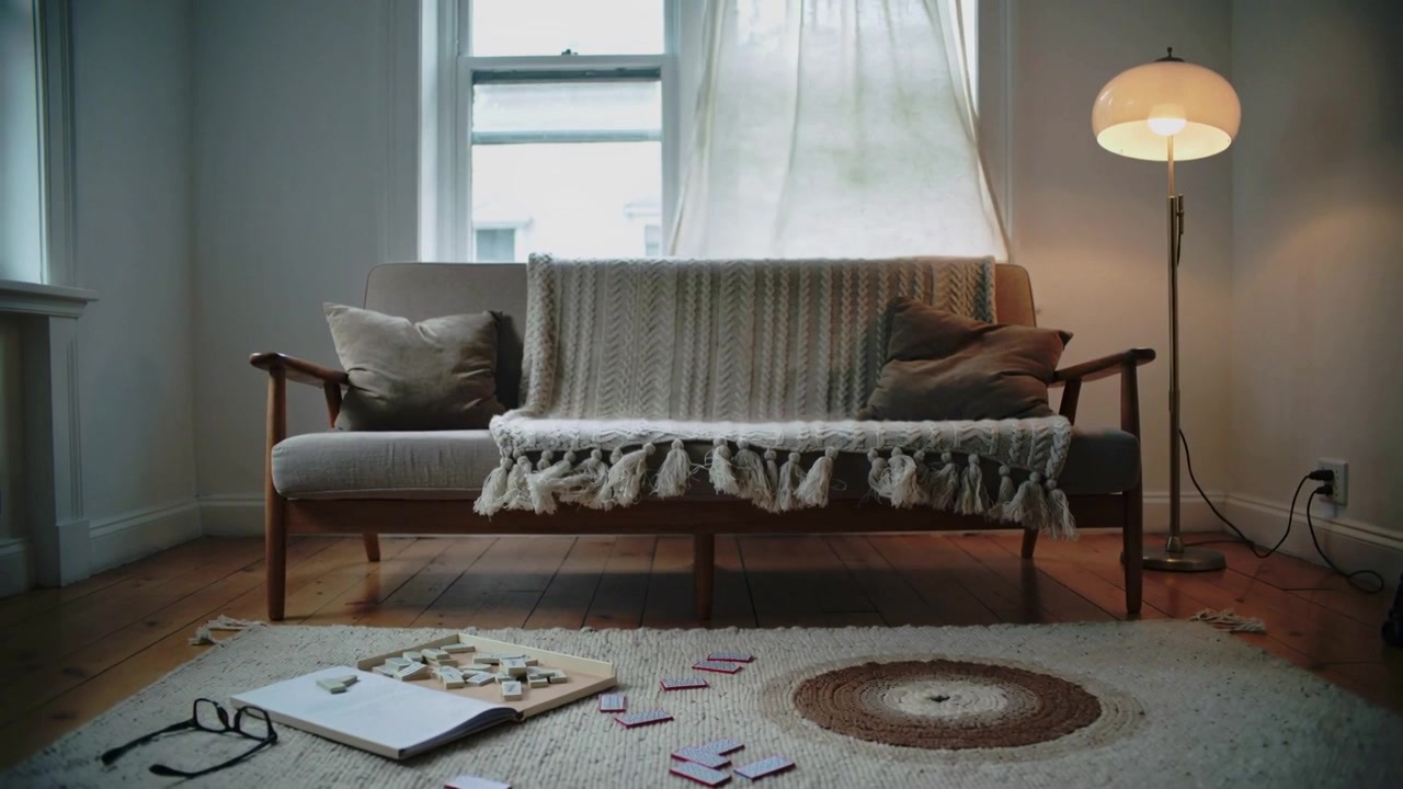 Billowing curtain from breeze causing midcentury sofa basking in soft light at home, with tiles