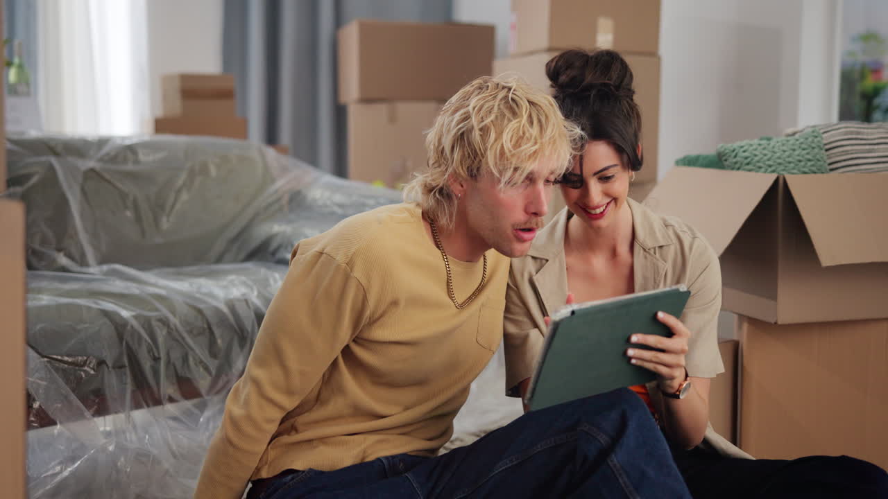 Young Couple Planning Their New Home on a Digital Tablet