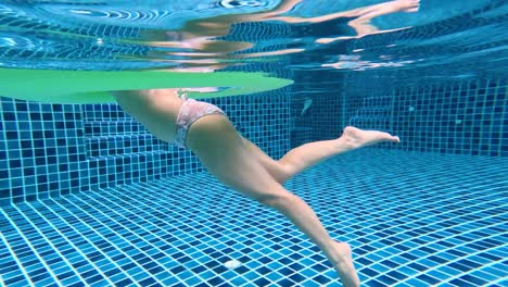 woman swimming underwater in a pool