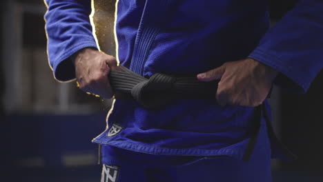 martial artist tying black belt