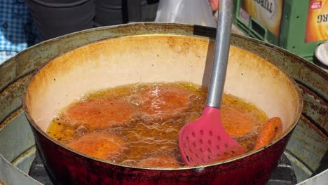 frying and stirring falafel