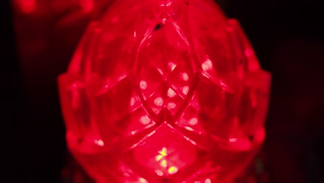 glowing red crystal-like lamp casting vibrant light, intense and mystical atmosphere