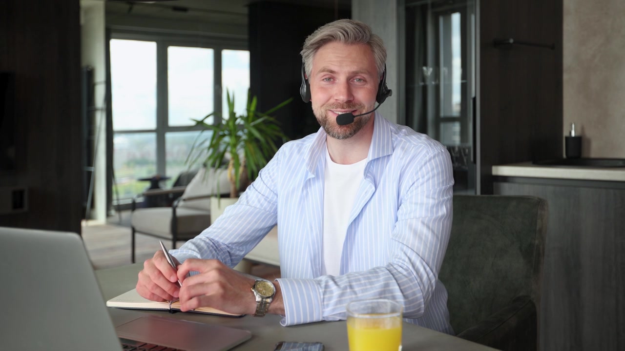 Professionel mand med headset taler under videoopkald