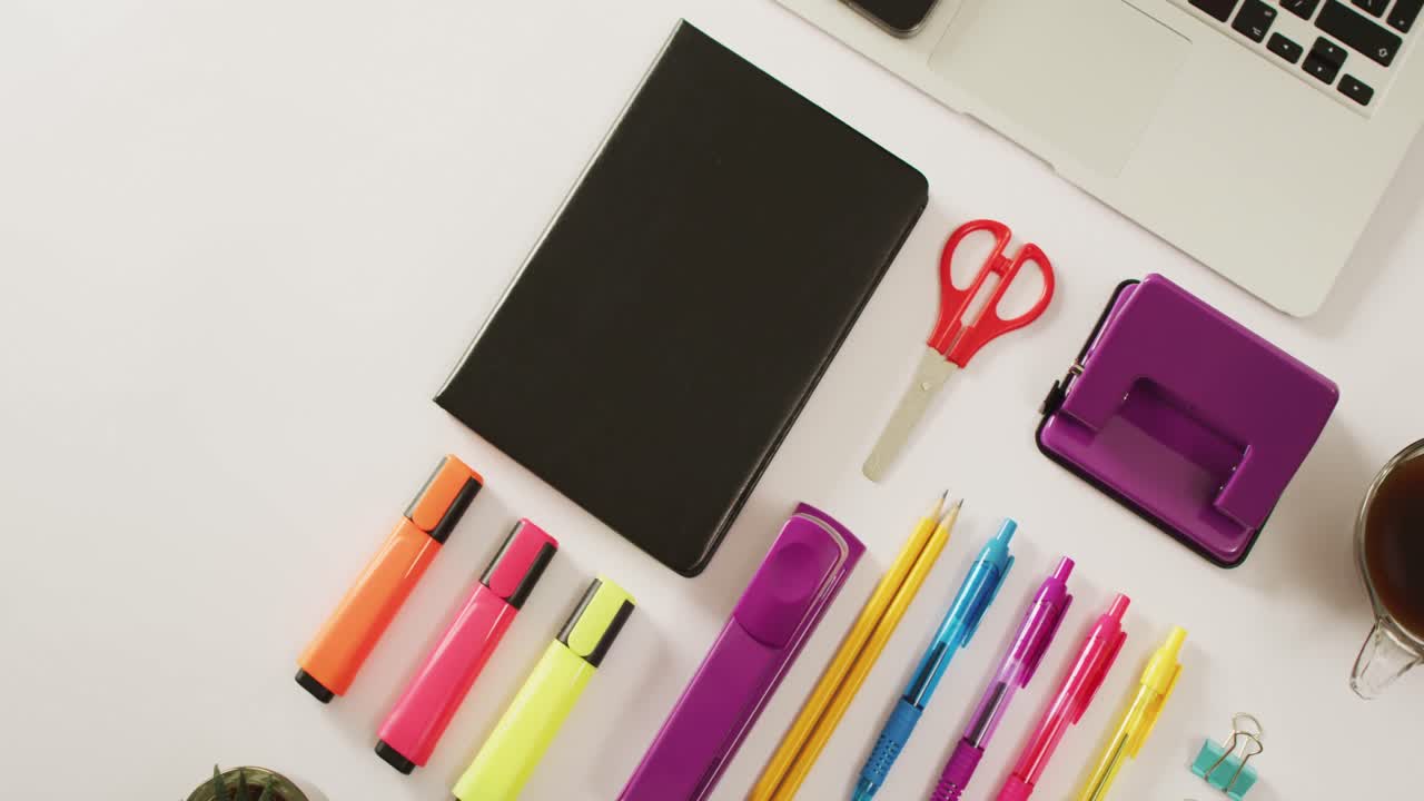 Video of composition with office equipment, laptop and notebook on white surface