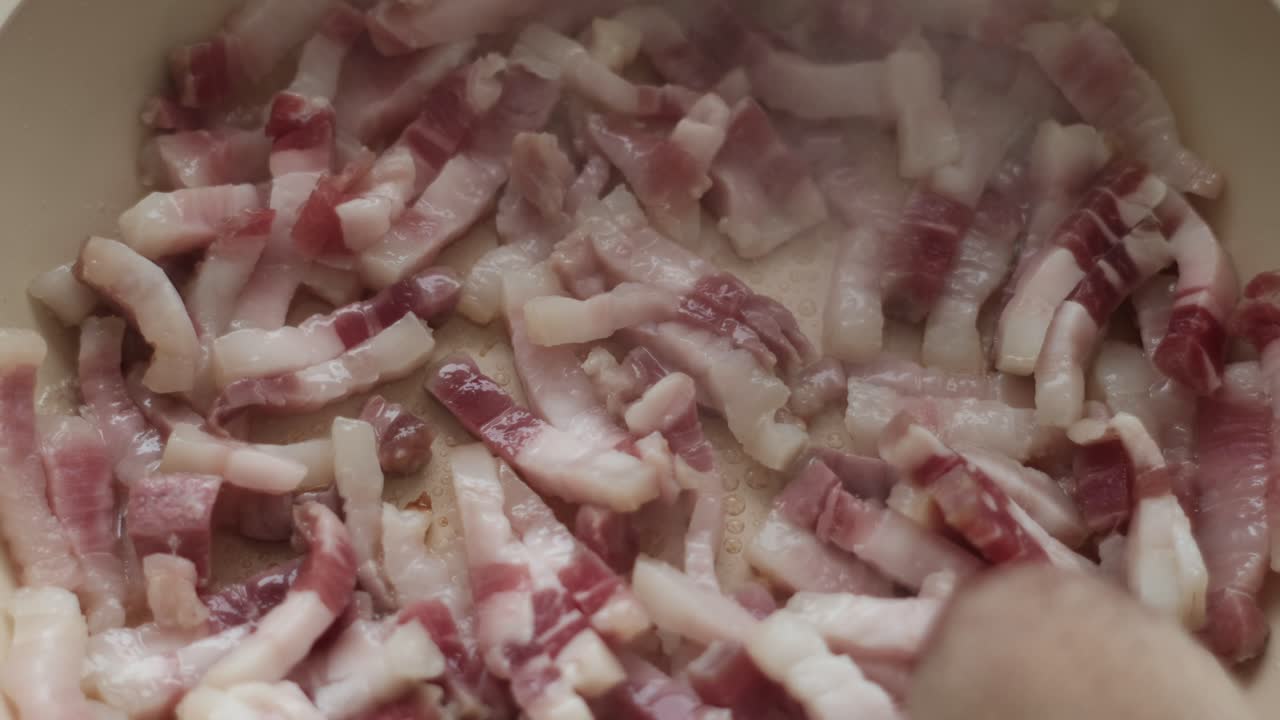 Mouthwatering Carbonara: Close-Up of Slow-Motion Pancetta and Guanciale Cooking on Pan