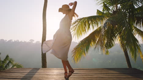 happy woman dancing celebrating vacation lifestyle on holiday with beautiful view of tropical jungle at sunrise 4k