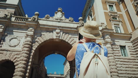 the tourist photographs a famous arch near the parliament in stockholm tourism in scandinavia concep