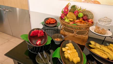 assorted fruits and dishes on a buffet table.