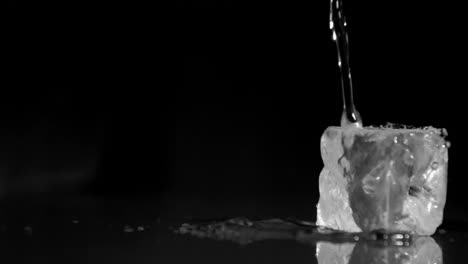 water in super slow motion falling on ice cubes