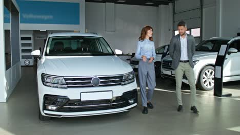 customer discussing car purchase in showroom