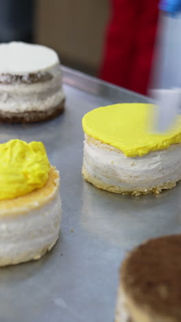 delicious cakes making in bakery. pastry chef cooking sweet dessert. vertical video