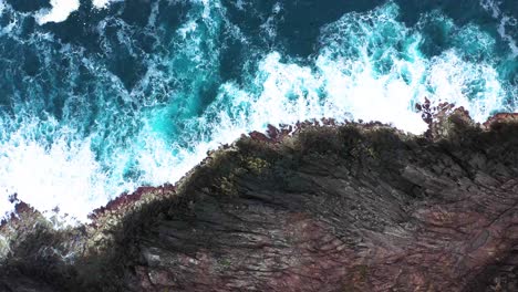 atlantic ocean waves crashing on rocky shoreline of terceira island