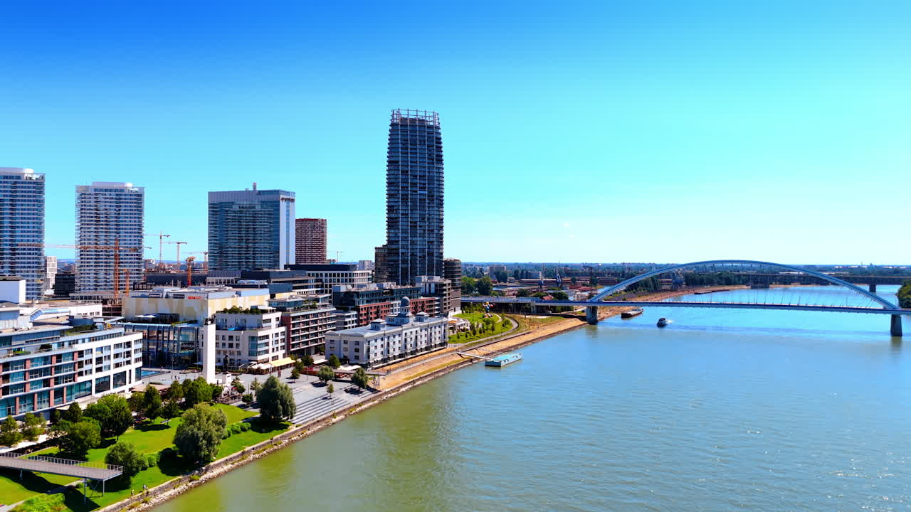 Daytime Bratislava skyline view. Bratislava's skyline by the river boasts modern architecture and clear skies, inviting exploration