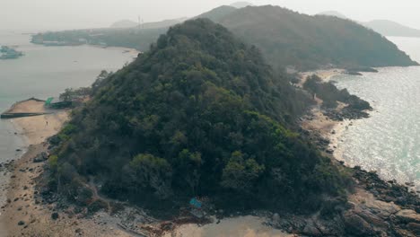 isla con verdes colinas forestales bañadas por el océano vista superior