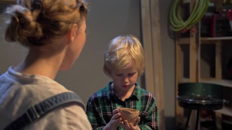 boy sculpts a cup with his hands in the workshop, slow motion