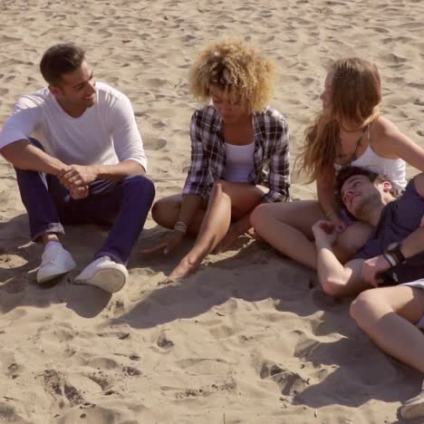 grupo de jóvenes amigos relajándose en la playa