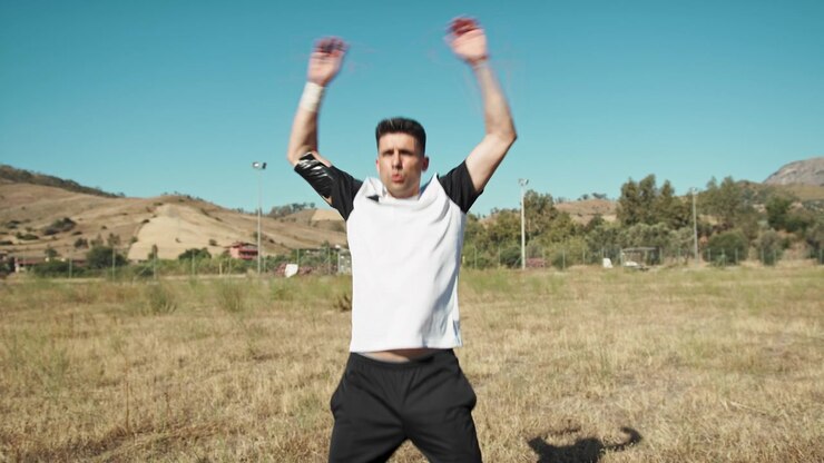 Soccer Player Doing Jumping Jacks To Warm Up