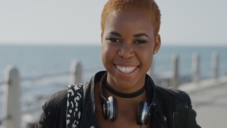 portrait successful young african american woman laughing enjoying independent lifestyle trendy black female student looking happy on seaside ocean background