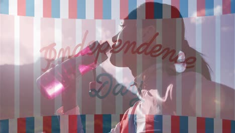 animation of independence day text over biracial woman drinking water and hiking