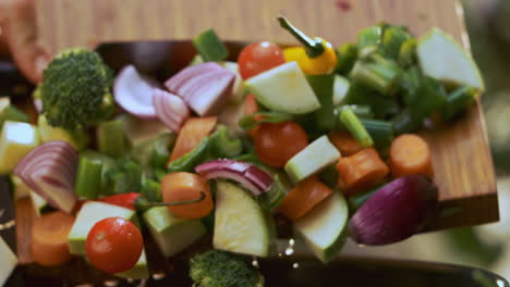 chopped vegetables being added to a pan