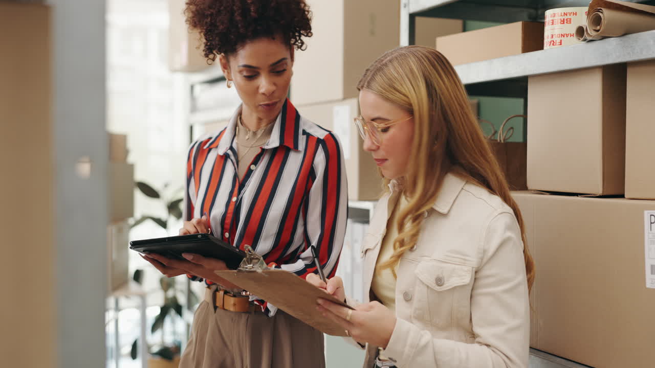 Two women doing inventory in a warehouse