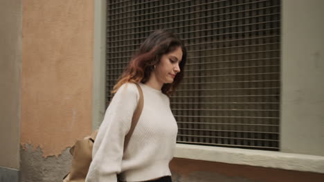 young girl smiling at the camera while walking in the street