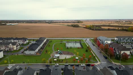 drone flying towards a neighborhood park on an overcast rainy day