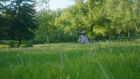 Black-Woman-on-picnic-in-park-running-away-to-low-angle-wide