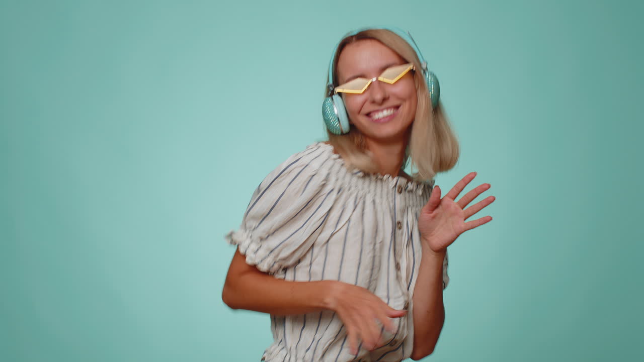 Funny girl listening music smiling dancing to disco party music rhythmically moving hands having fun
