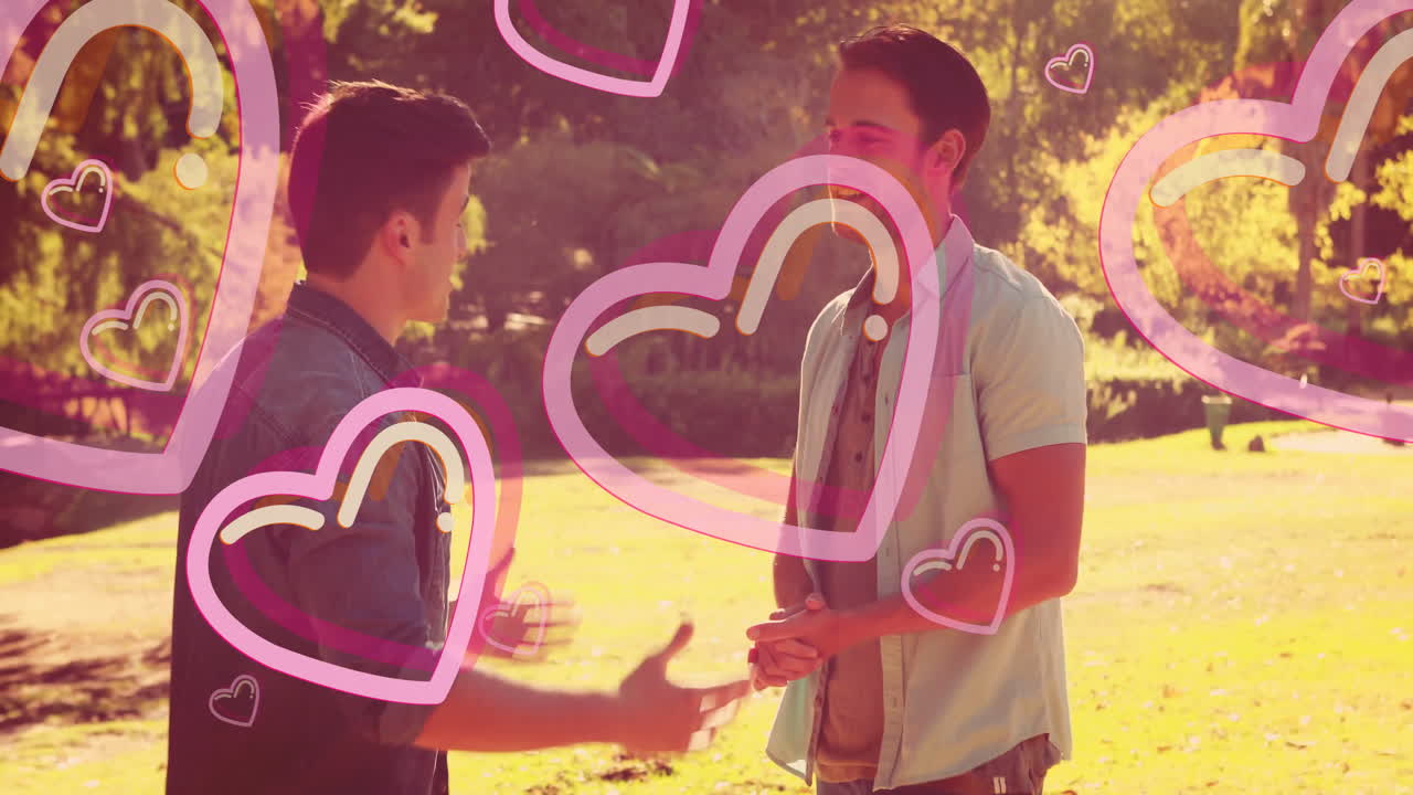 Two people talking in park with pink heart animation overlay