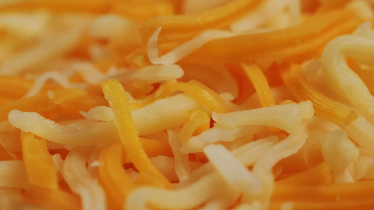 Some different sorts of grate cheese on plate close up macro. Chef grating cheese mozzarella, cheddar for meals. Itallian food, pizza, pasta. High quality 4k footage