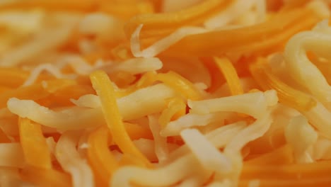 some different sorts of grate cheese on plate close up macro. chef grating cheese mozzarella, cheddar for meals. itallian food, pizza, pasta. high quality 4k footage