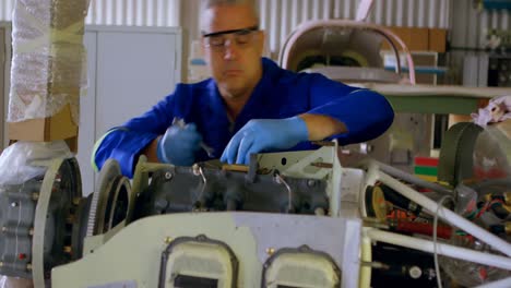 engineer repairing aircraft in hangar 4k