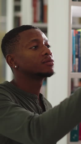 black guy takes books from assistant in library. african american man gathers literature with librarian assistance in college storage. constant reader