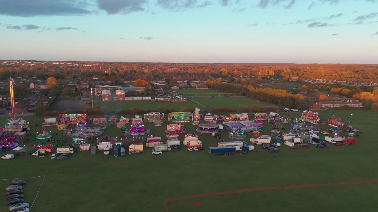 Aerial view of a colorful fairground at sunset in Thetford, Norfolk, UK