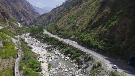 drone shot of a small road and river in himachal pradesh near manali, kasol-3