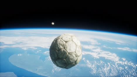 old soccer ball in space on earth orbit