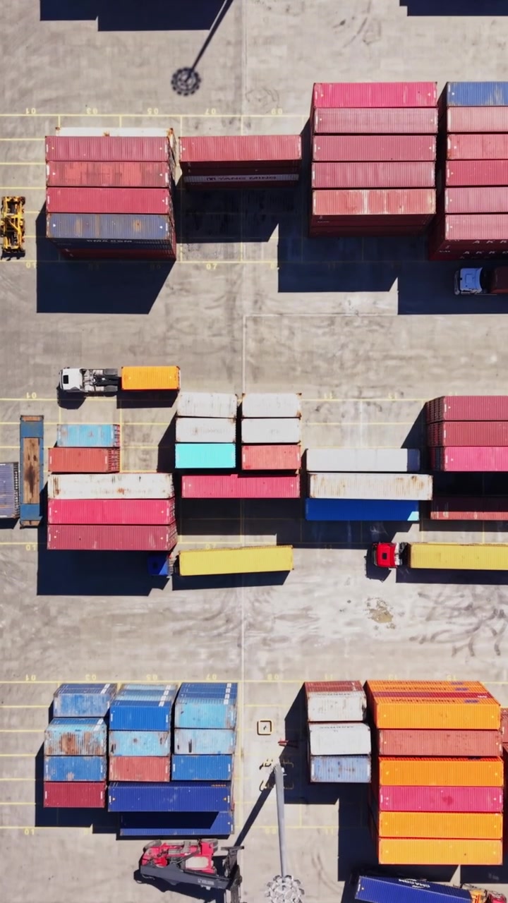 Cargo containers stacked in port area during daytime